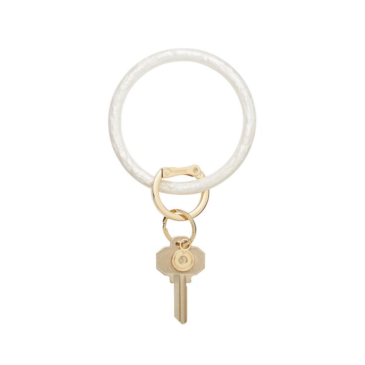 a white keychain with a gold ring and two keys hanging from the end