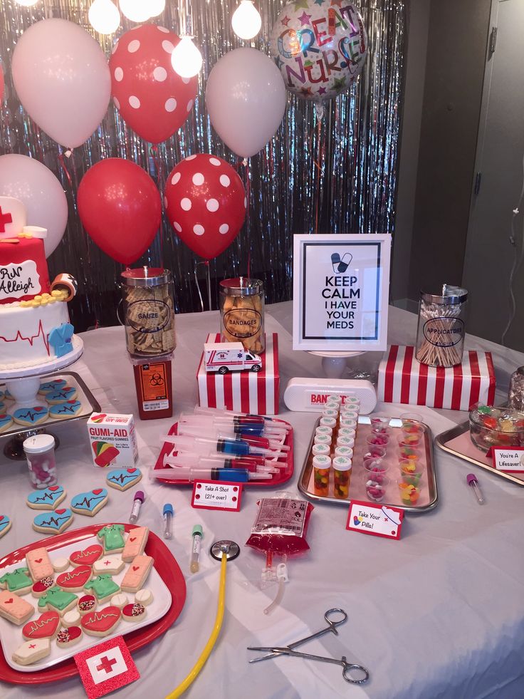 a table topped with lots of desserts and balloons