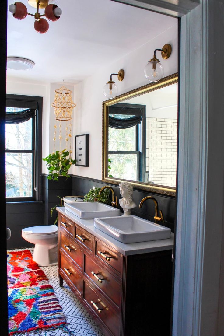 a bathroom with two sinks and a rug on the floor in front of it's door