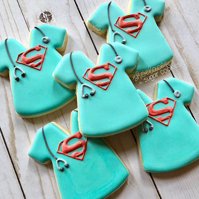 decorated cookies are arranged in the shape of nurse's shirts and stethoscopes