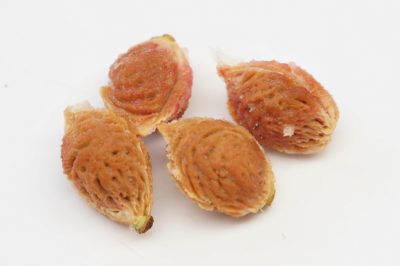 three pieces of fruit sitting on top of a white surface