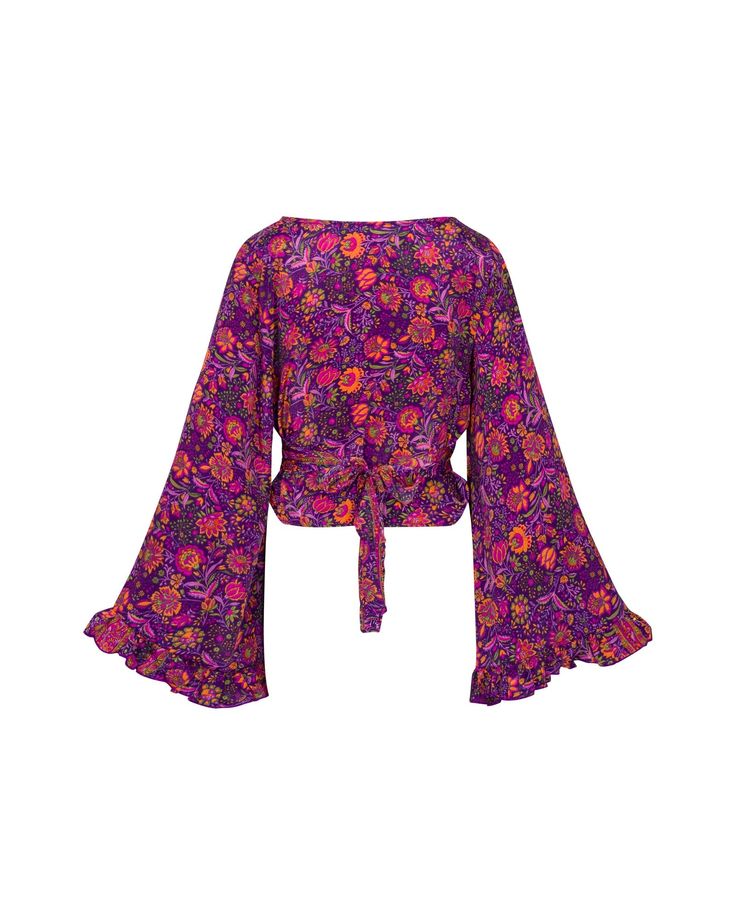 Feel like free spirited hippie queen every day in this versatile floral wrap top. Featuring a vibrant floral pattern, this beautiful top is perfect for all occasions. This top can be worn open, tied in the front, or wrapped and tied in the back making it as versatile as it is fabulous! The wide bell sleeves are reminiscent of 70s style, with a ruffled hem added for flair. The buttery soft and lightweight fabrication is guaranteed to make you feel as good as you look. Whether you wear this top to Bohemian V-neck Peasant Top With Floral Print, Multicolor Floral Print V-neck Peasant Top, Bohemian Floral Print Tops For Fall, Purple Floral Print Top For Day Out, Spring Hippie Blouse For Day Out, Spring Day Out Hippie Blouse, Floral Print V-neck Peasant Top For Beach, Bohemian Wrap Top For Day Out, Flowy Hippie Tops For Day Out