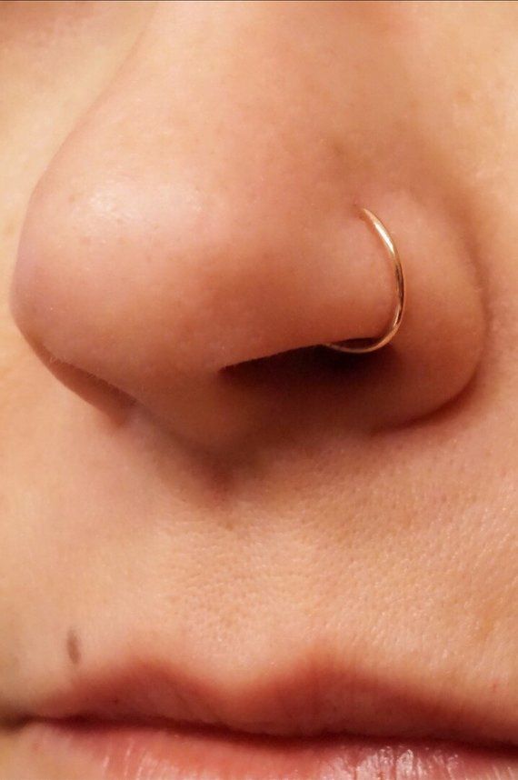 a woman's nose with a nose ring on top of her nose and the bottom part of her nose