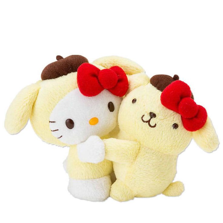 two stuffed animals that are sitting next to each other on a white surface, one has a red bow on it's head