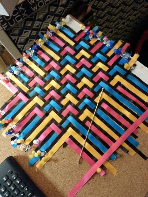 a computer keyboard sitting on top of a desk next to a colorful piece of art