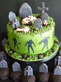 a cake decorated with zombie figures and tombstones