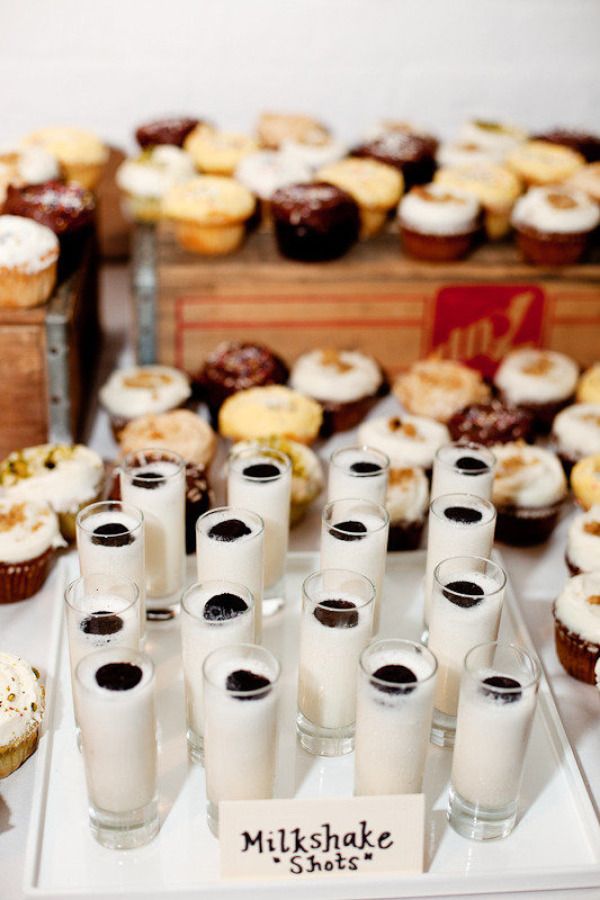 a table topped with lots of different types of cupcakes