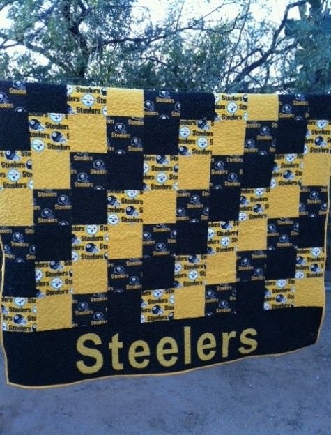 a black and yellow quilt with the word steeles on it