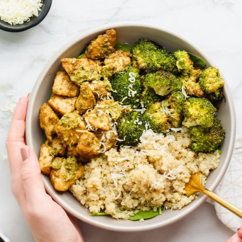 a bowl filled with rice, broccoli and tofu