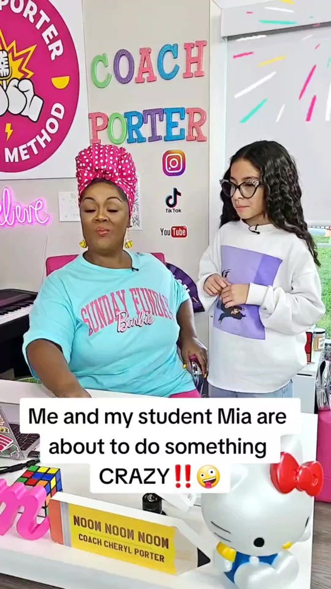 two girls are standing in front of a desk with a sign that says me and my student mia are about to do something crazy