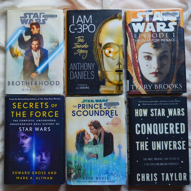 six star wars books laid out on a bed