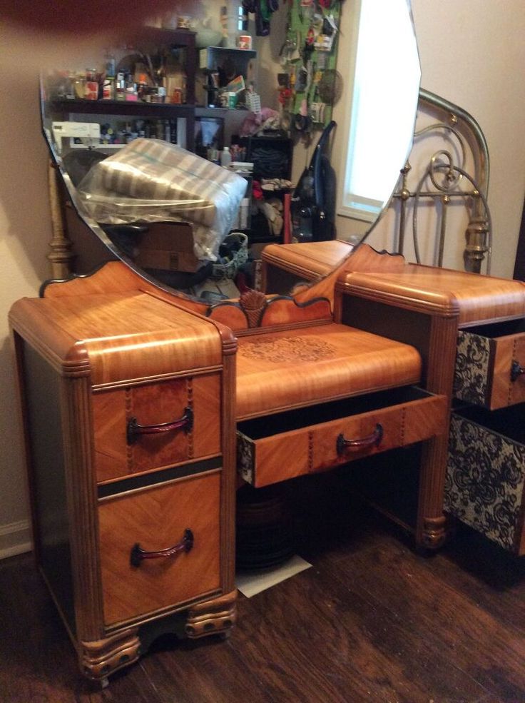 an antique dressing table with mirror and drawers