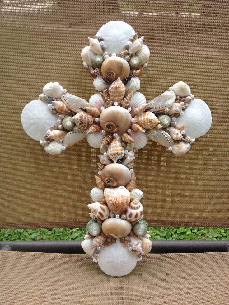 a cross made out of seashells on display