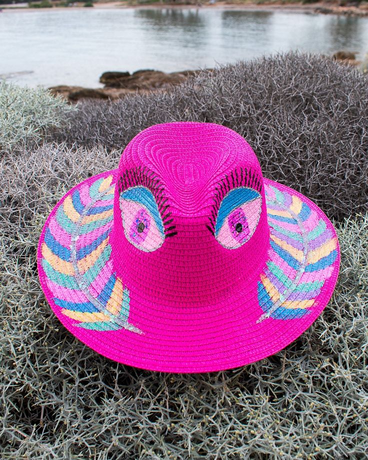 *Hand painted fuchsia straw hat, with two colorful big eyes drawn on both sides of the top of the hat, and colorful feathers drawn on the brim. It's painted with vibrant acrylic colors with glitter! *Made in Greece 🇬🇷 with love ❤️  *Perfect for an unforgettable cute look 🥰 ☛ Crown Size: 57cm *Hand painted with high quality acrylic colors to protect the design from weather and water💦 Funky Pink Hats For The Beach, Funky Pink Hat For The Beach, Pink Bohemian Straw Hat With Flat Brim, Fun Pink Fedora Hat, Funky Wide Brim Beach Hat, Funky Wide Brim Hat For Beach, Pink Fedora Hat Fun Style, Pink Curved Brim Straw Hat For Festival, Pink Handmade Sun Hat For Festival