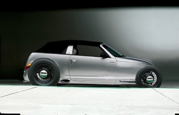 a silver car parked in front of a black wall