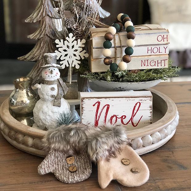 a wooden tray with christmas decorations on it