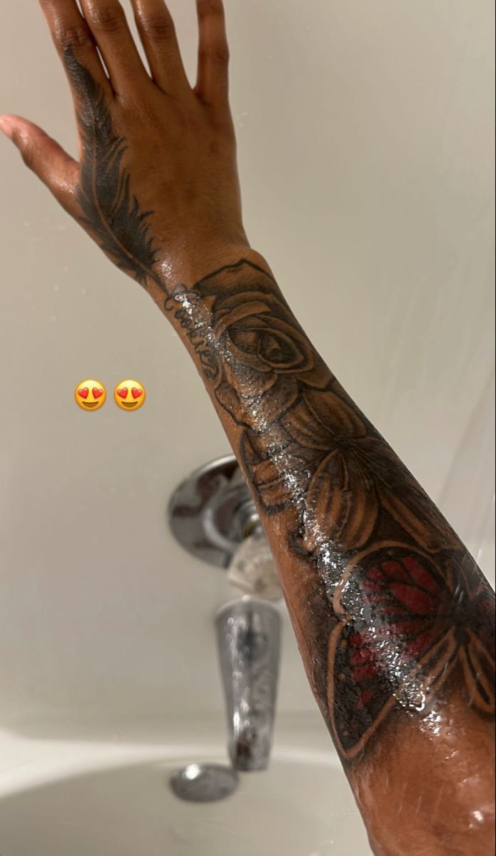 a person's arm and hand with tattoos on it