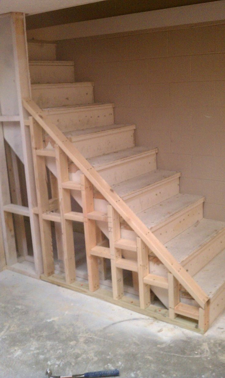 an unfinished room with some stairs in it