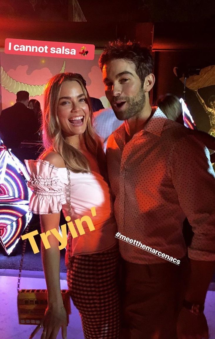 a man and woman standing next to each other in front of a neon sign that says i cannot't salsa