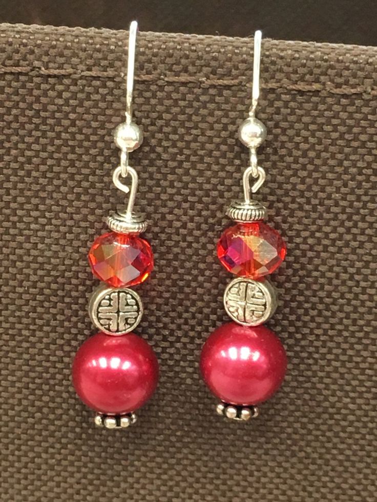 Red glass beads, red pearl beads with Asian inspired silver accents. Red Pearl, Asian Inspired, Silver Accents, Red Glass, Pearl Beads, Earrings Handmade, Jewelry Earrings Dangle, Beaded Jewelry, Beading