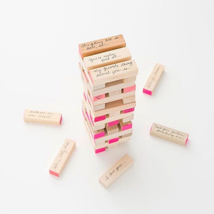 a stack of wooden blocks sitting on top of each other next to pink and white erasers