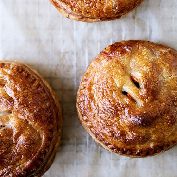 three pastries sitting on top of a piece of wax paper next to each other