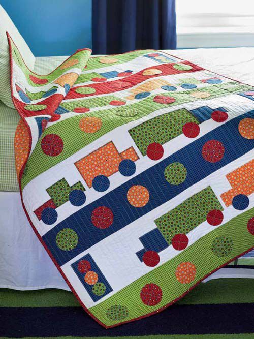 a bed with a colorful quilt on top of it