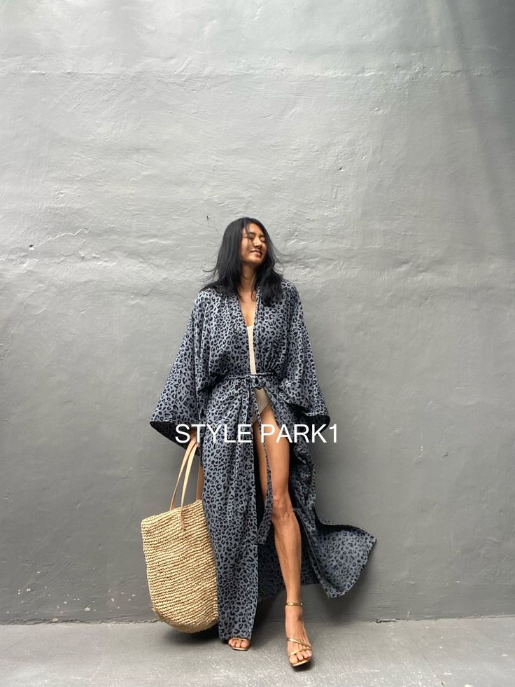 Leopard Kimono long jacket, It's made by the Bali's traditional hand Print If you are very small this may be too big. Stylepark1 Model -Her height is 175Cm/5.74ft weight is 64kg/141.09Ib /American size, she wore ~ M to large size. Made from soft Rayon At first, you may smell of the unique dye. It will disappear after you wash it. So do not worry. color - Bali Hand print gray base & black motif Model wore / A A - Length - 150cm /59inch Width - Chest & hip 75cm/150cm (59inch) round I recommend Ame Oversized Long Sleeve Robe For Beach Cover-up, Oversized Long Beach Robe, Traditional Fall Kimono For Vacation, Traditional Spring Beach Outerwear, Traditional Open Front Kimono For Vacation, Oversized Black Outerwear For The Beach, Long Kimono For Fall Vacation, Long Fall Kimono For Vacation, Traditional Long Sleeve Kimono For Beach