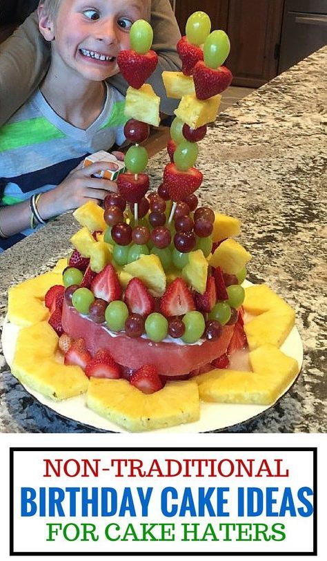 a young boy sitting in front of a cake with fruit on it and the words, non - traditional birthday cake ideas for cake haters