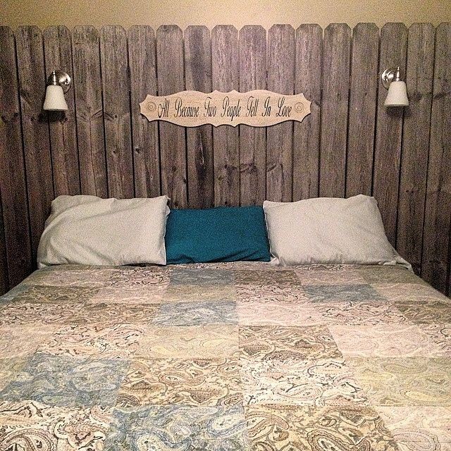 a bed with two lamps on either side of the headboard and pillows on both sides