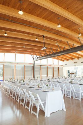 a large room with tables and chairs set up for a formal function in the center