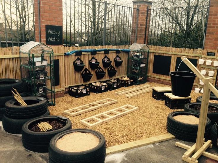 a group of tires sitting on top of a floor next to each other in front of a fence