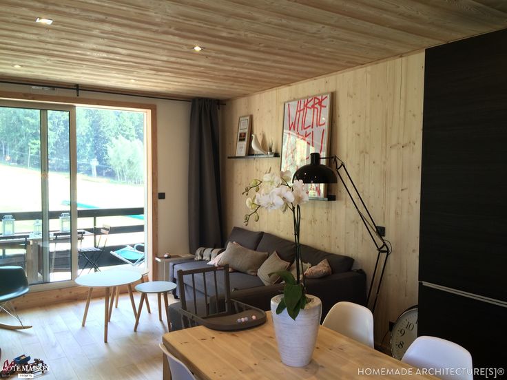 a living room filled with furniture and a wooden table in front of a sliding glass door