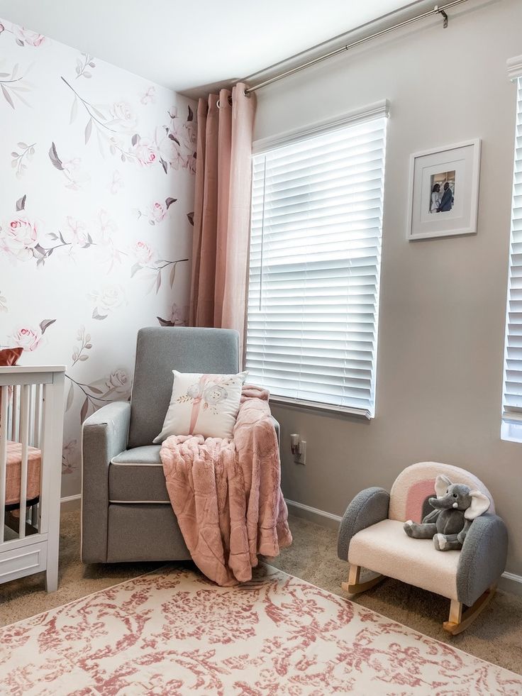 a baby's room with pink and gray decor