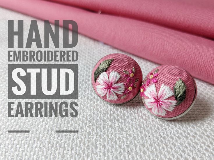 pink fabric with white flowers on it and the words hand embroidered stud earrings written below