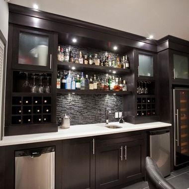 a home bar with wine bottles on the shelves