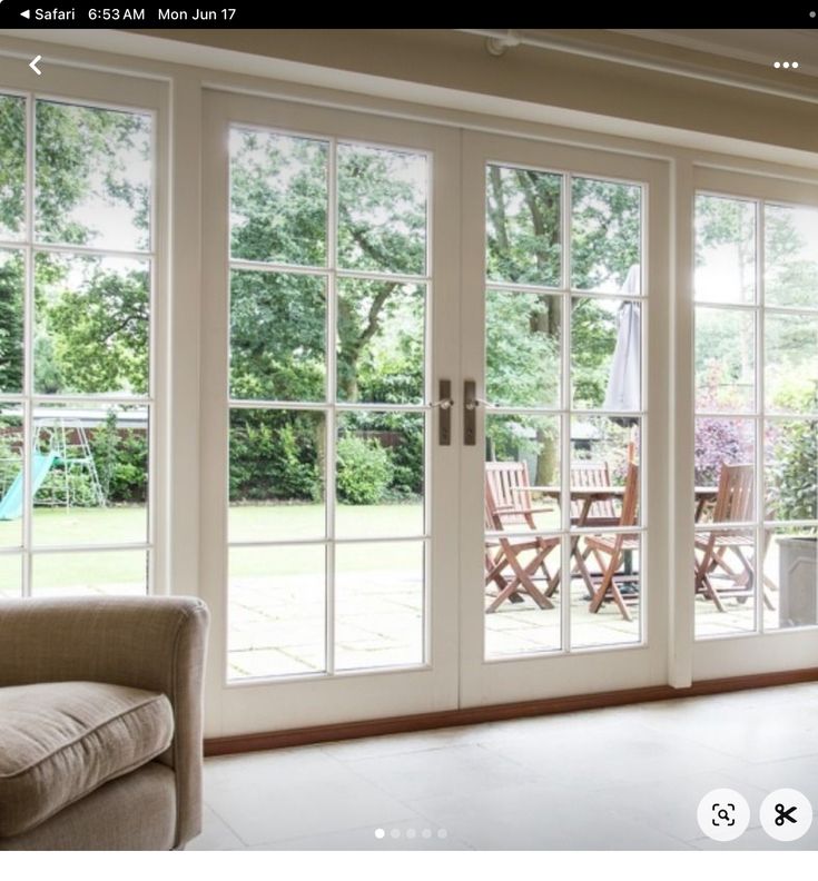 a living room filled with furniture and sliding glass doors