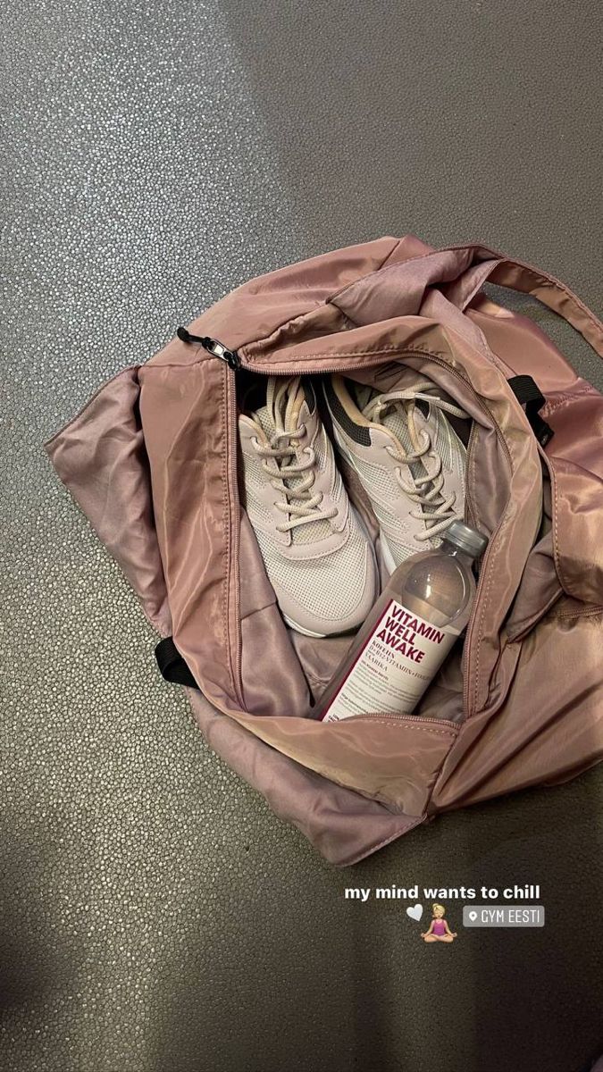 an open bag with shoes in it sitting on the floor