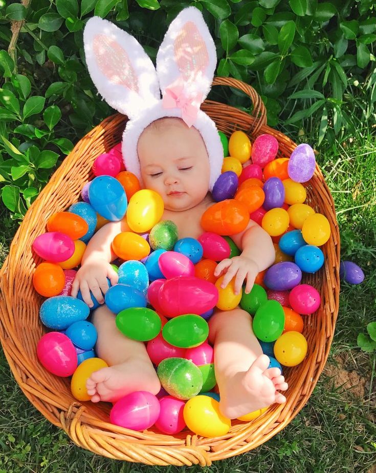 a basket filled with lots of colorful eggs and bunny ears on top of it, next to the words easter basket ideas for girls age 1 - 3