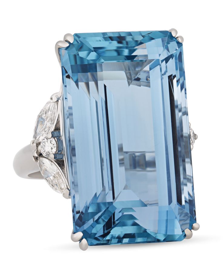 With the stunning blue hue of a clear tropical ocean, the incredible 43.37-carat emerald-cut aquamarine at the center of this ring is absolutely captivating. This specimen possesses the deeply saturated Santa Maria blue hue that is found only in the rarest variety of these stones. Named in honor of Santa Maria de Itabira, the mine in Brazil where they were first discovered, aquamarines that possess this "deep sea" color are highly sought after. This gem is joined by 1.21 carats of marquise- and Emerald Cut Aquamarine Ring, Tropical Ocean, Contemporary Engagement Rings, Platinum Diamond Engagement Rings, Platinum Diamond Rings, Modern Engagement Rings, Aquamarine Ring, Deco Engagement Ring, Aquamarine Rings