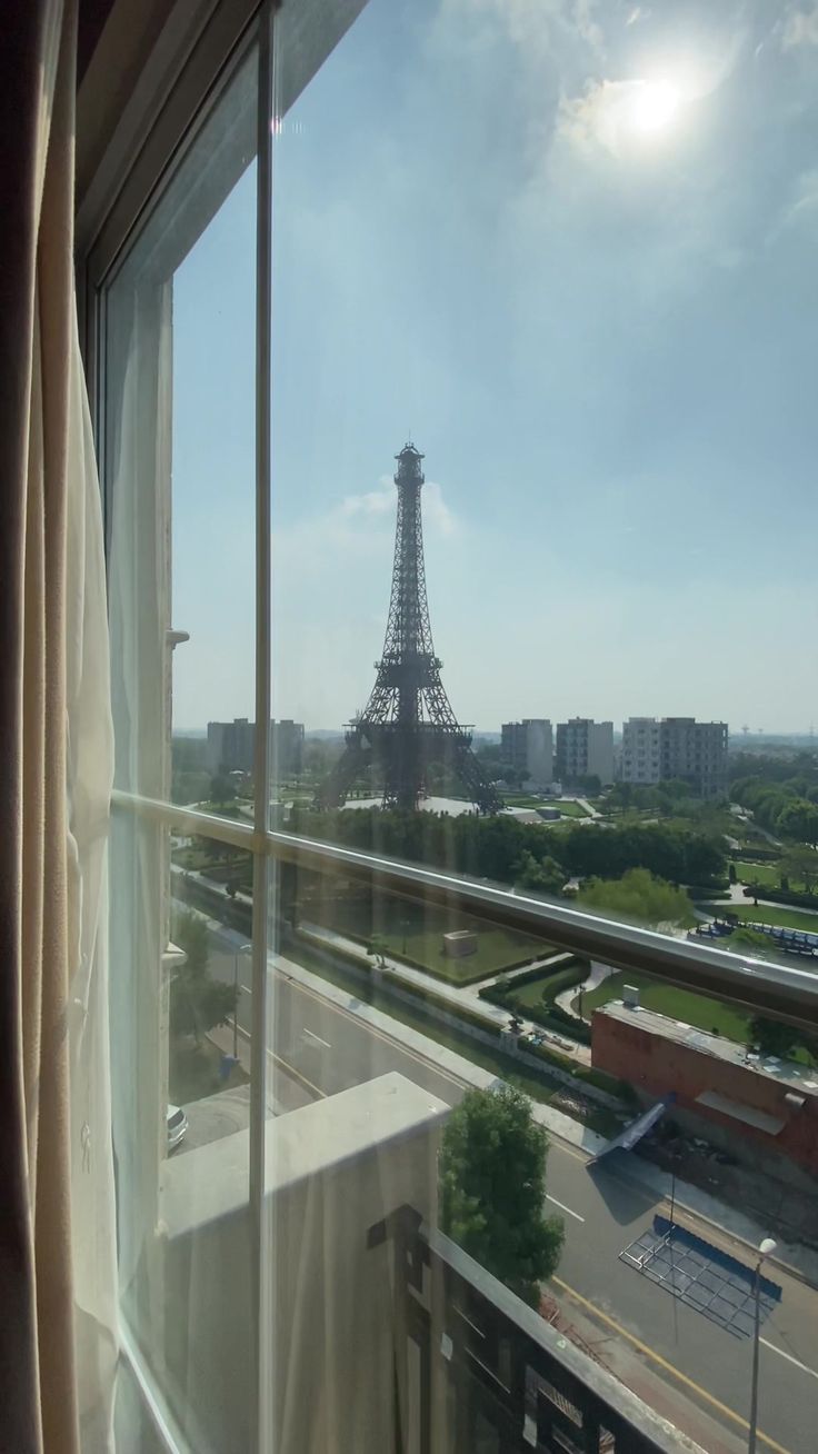 the eiffel tower is seen through a window