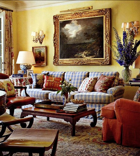 a living room filled with furniture and a painting on the wall