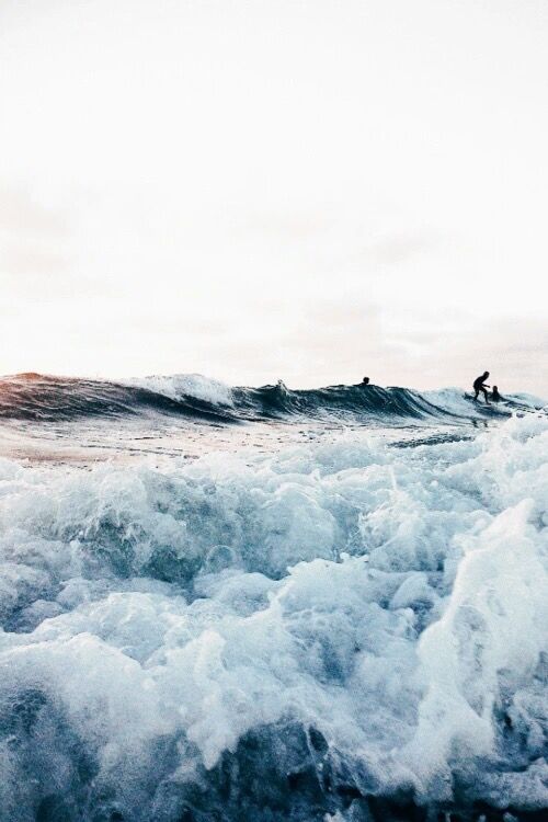 a person riding a wave on top of a surfboard