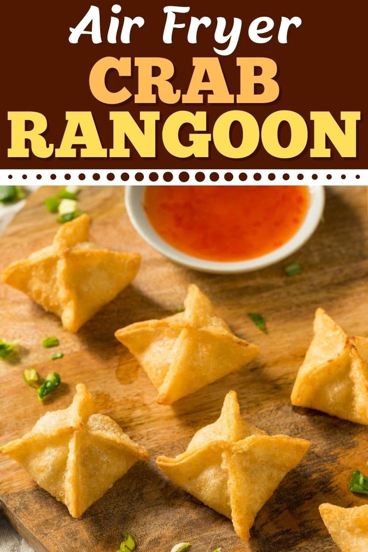 air fryer crab rangoon on a cutting board with dipping sauce