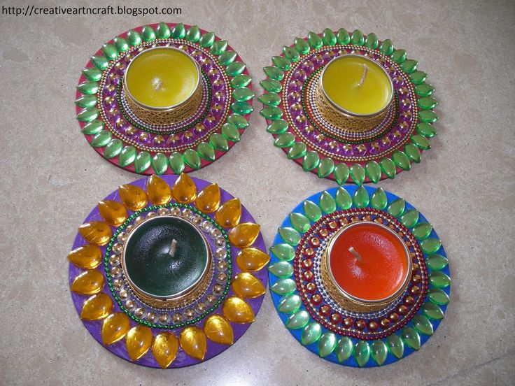 three colorful plates with candles in them on a table