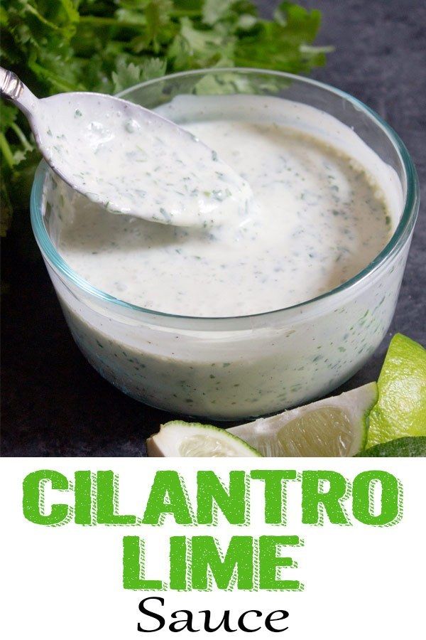 a spoon in a small glass bowl filled with cilantro lime sauce