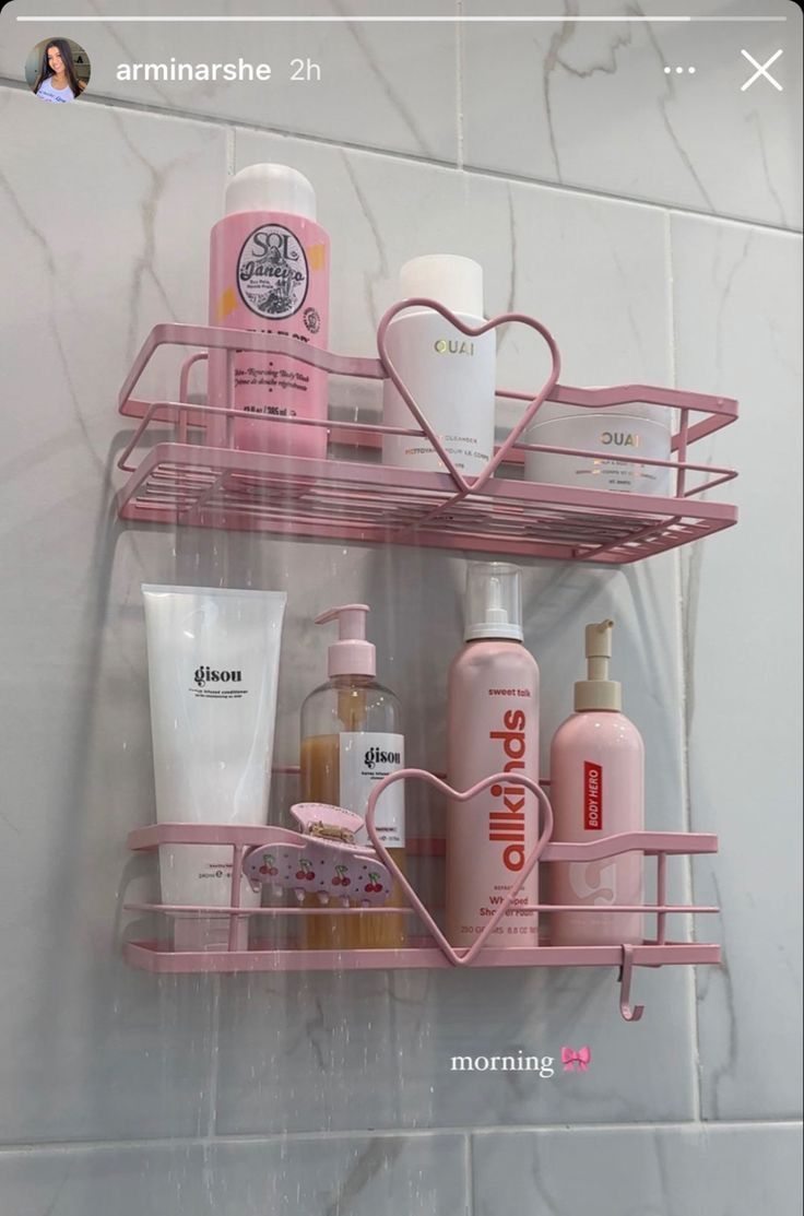 pink bathroom shelf with soap, shampoo and lotion on it in the shower