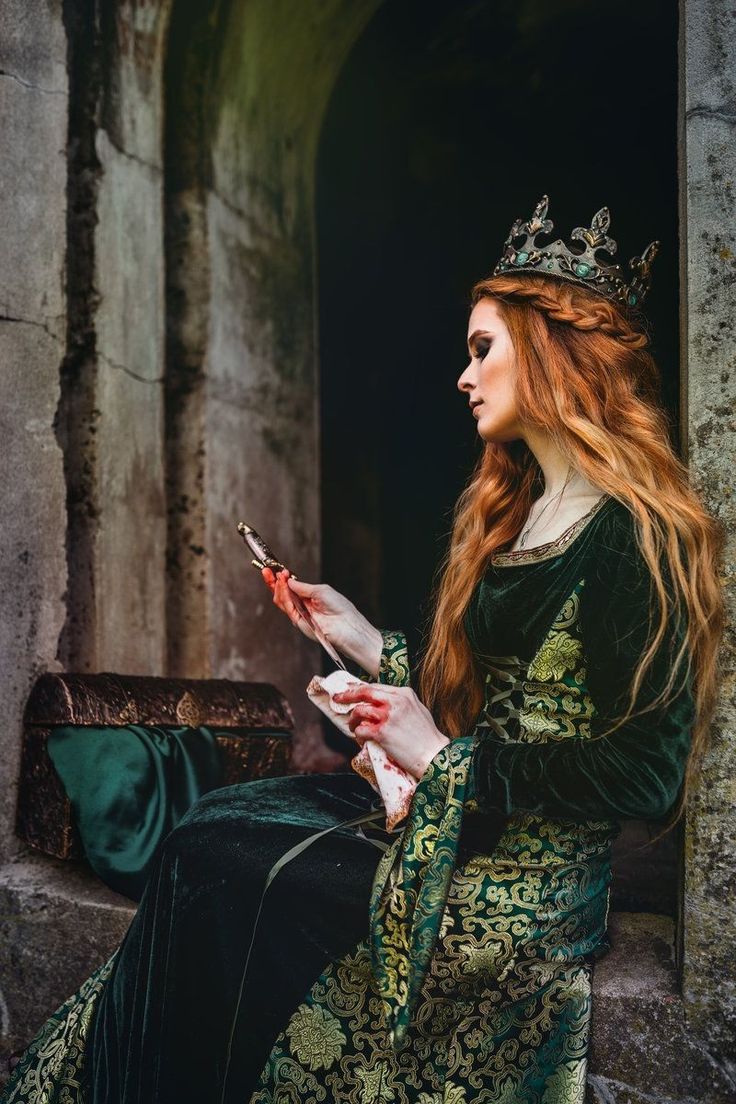 a woman in a green dress is sitting down