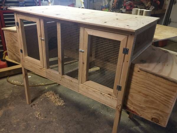 a large wooden cabinet with two cages on it's sides in a shop area