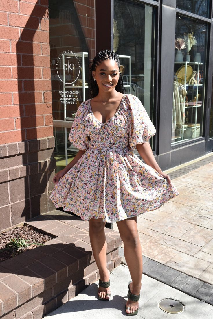 Floral print short raglan puff sleeve v-neck shirring waist detail babydoll mini dress. "Add a playful touch to your wardrobe with our Floral Print V-Neck Puff Sleeve Mini Dress. Featuring a flattering v-neckline, shirred waist, and short puff sleeves, this babydoll dress is perfect for any occasion.